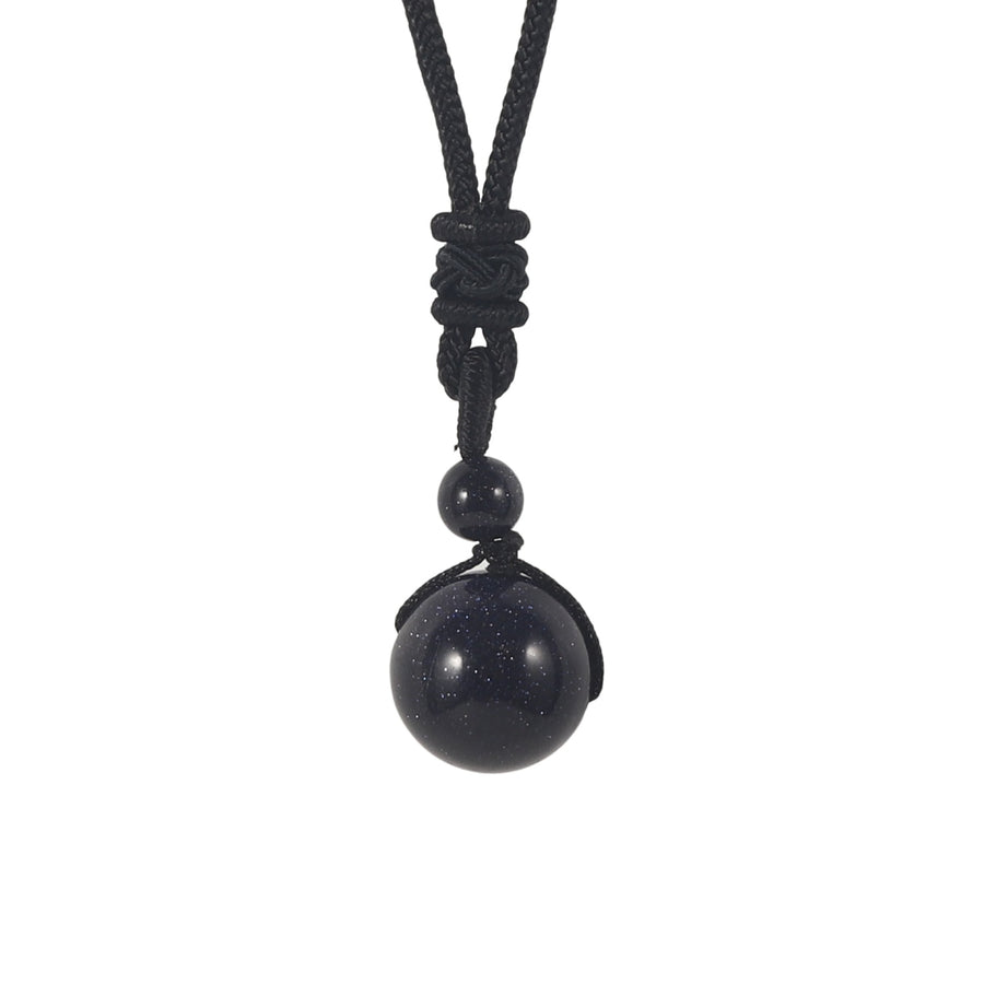 Close-up of a black natural stone bead pendant on a black cord necklace
