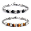 Close up of a silver tone chain bracelet with brown tiger eye beads