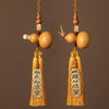 Two natural gourd car hanging ornaments with gold tassels and coins