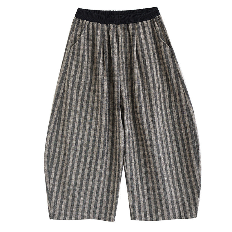 Model wearing grey striped wide leg corduroy pants with black shoes
