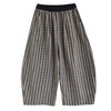 Model wearing grey striped wide leg corduroy pants with black shoes