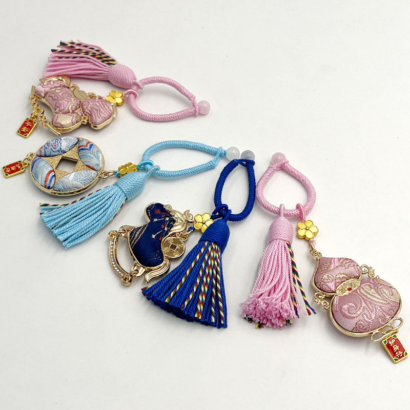 Assortment of colorful Song brocade keychains with tassels and gold-tone charms