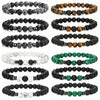 Three beaded bracelets featuring tiger eye, black lava rock, and white howlite stones on a white background