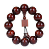 Close up of a red sandalwood beaded bracelet with a square wooden charm