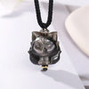 Close up view of a silver sheen obsidian fox pendant on a black cord