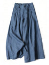 Blue wide leg linen pants with elastic waist and pockets laid flat on white background