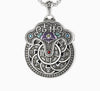 Close up of a silver tone copper pendant with a purple flower and coin design on a box chain