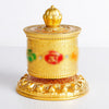 Gold-tone Tibetan prayer wheel with spinning mantra cylinder