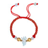 Close up of a red woven bracelet with a light green jade animal charm and silver beads