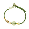 Green braided bracelet with a pale jade peace buckle and gold-tone flower knot details
