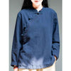Woman wearing a navy blue loose cotton linen shirt with an oblique collar and knot buttons