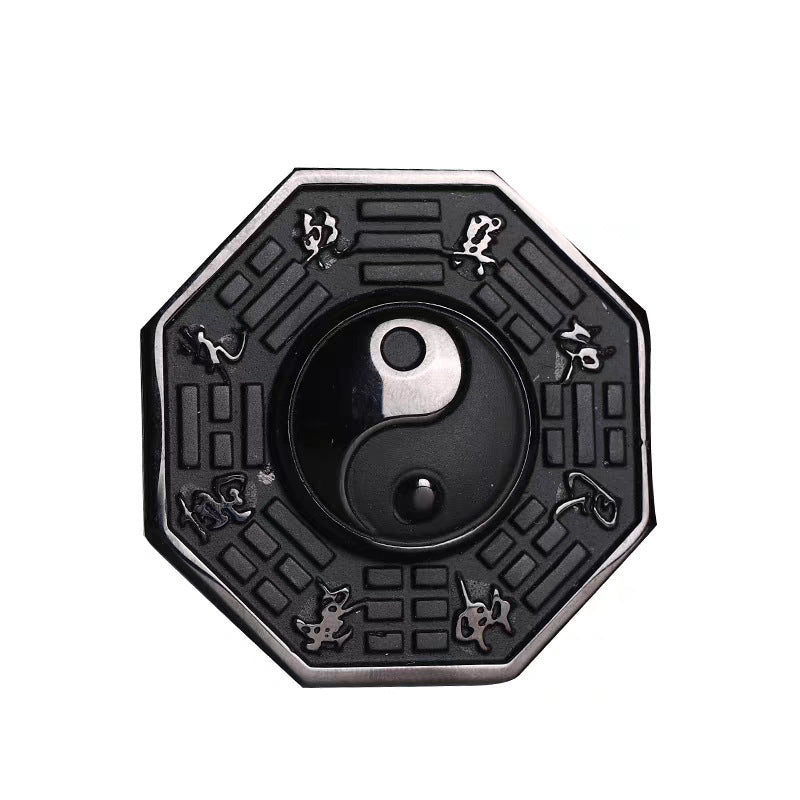 Close up of an octagonal black obsidian pendant with silver-tone trigrams and a central Yin Yang symbol