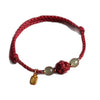 Red woven bracelet with cinnabar bead and gold charm
