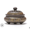 Round ceramic incense burner with blue and gold geometric patterns on a white background