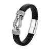 Close up of a black braided leather bracelet with a gold tone horseshoe clasp