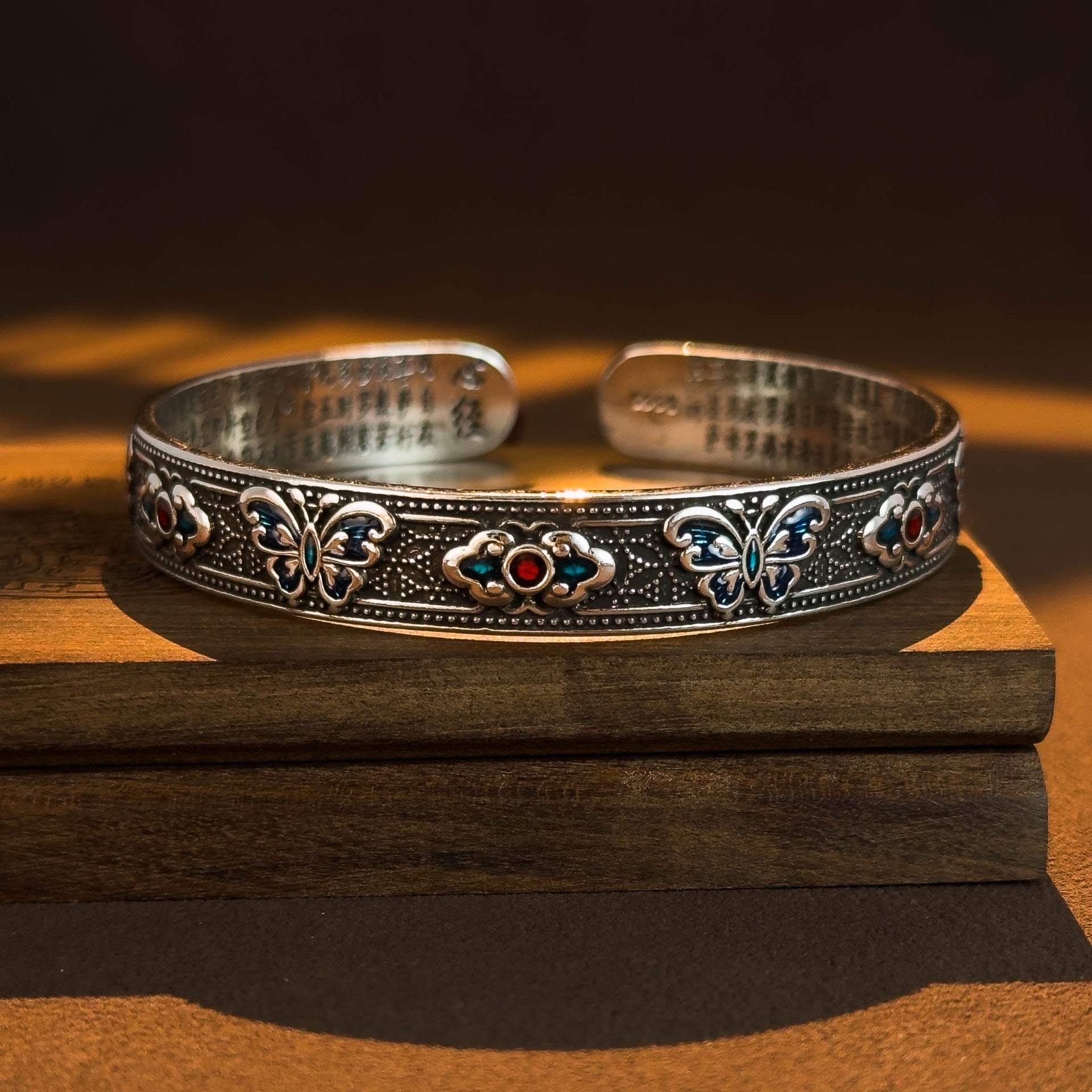 Antique silver tone copper bangle with blue enamel butterflies and engraved text on the inside