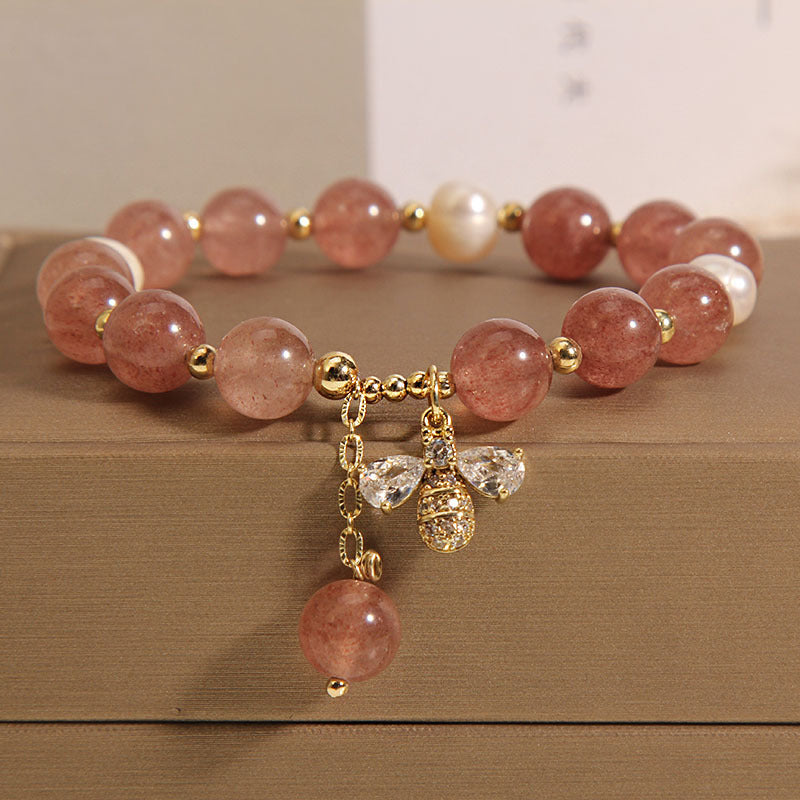 Pink strawberry quartz bracelet with pearl accents and a gold bee charm