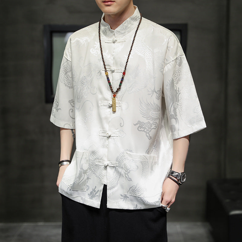 Man wearing a white short sleeve shirt with a subtle dragon pattern and traditional buttons