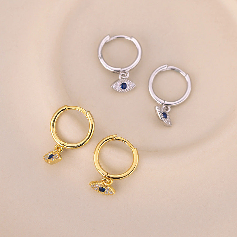 Pair of gold-tone and silver-tone hoop earrings with blue evil eye charms