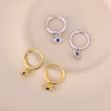 Pair of gold-tone and silver-tone hoop earrings with blue evil eye charms