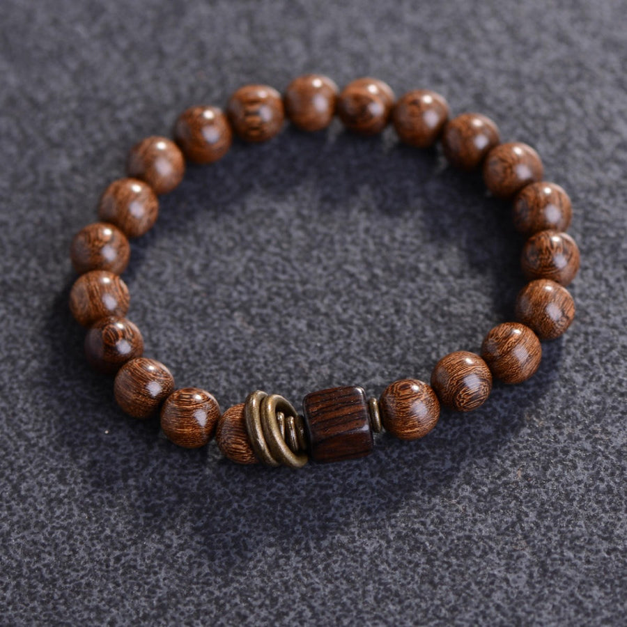 Close up of golden silk sandalwood bracelet with square accent bead
