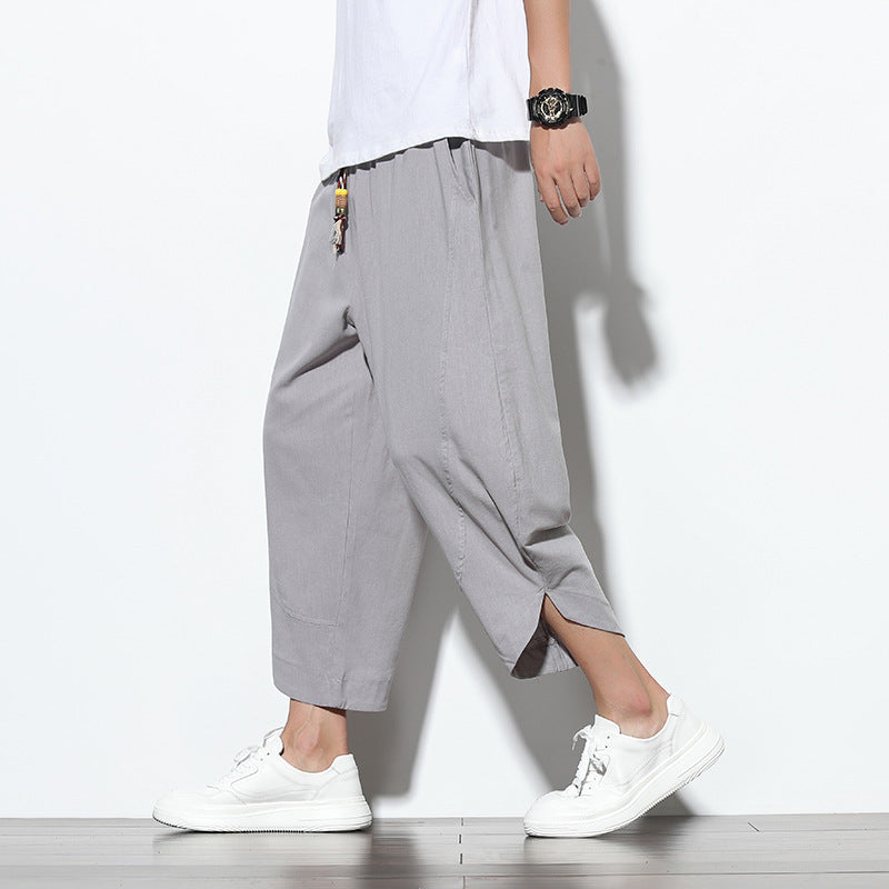 Front view of men wearing grey cotton linen harem pants with drawstring waist