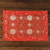 Close up of red, yellow and blue brocade fabric with dragon and lotus patterns