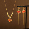 Gold tone necklace and earrings set with red maple leaf pendants