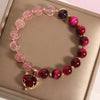 Pink strawberry quartz and red tiger eye beaded bracelet with a gold fox charm