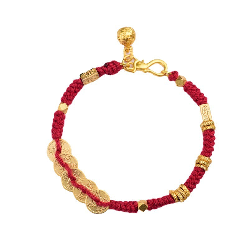 Close up of a red braided bracelet with five gold coins and gold tone beads