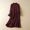 Front view of a long sleeve plaid midi dress with buttons and pockets