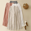 Four pairs of women's wide leg pants in orange, grey, apricot and white with elastic waists