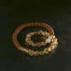 Double wrap bracelet with yellow citrine crystals and brown bodhi seeds on a dark background