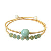 Gold-tone wire cuff bracelet with green jade center bead and white pearls
