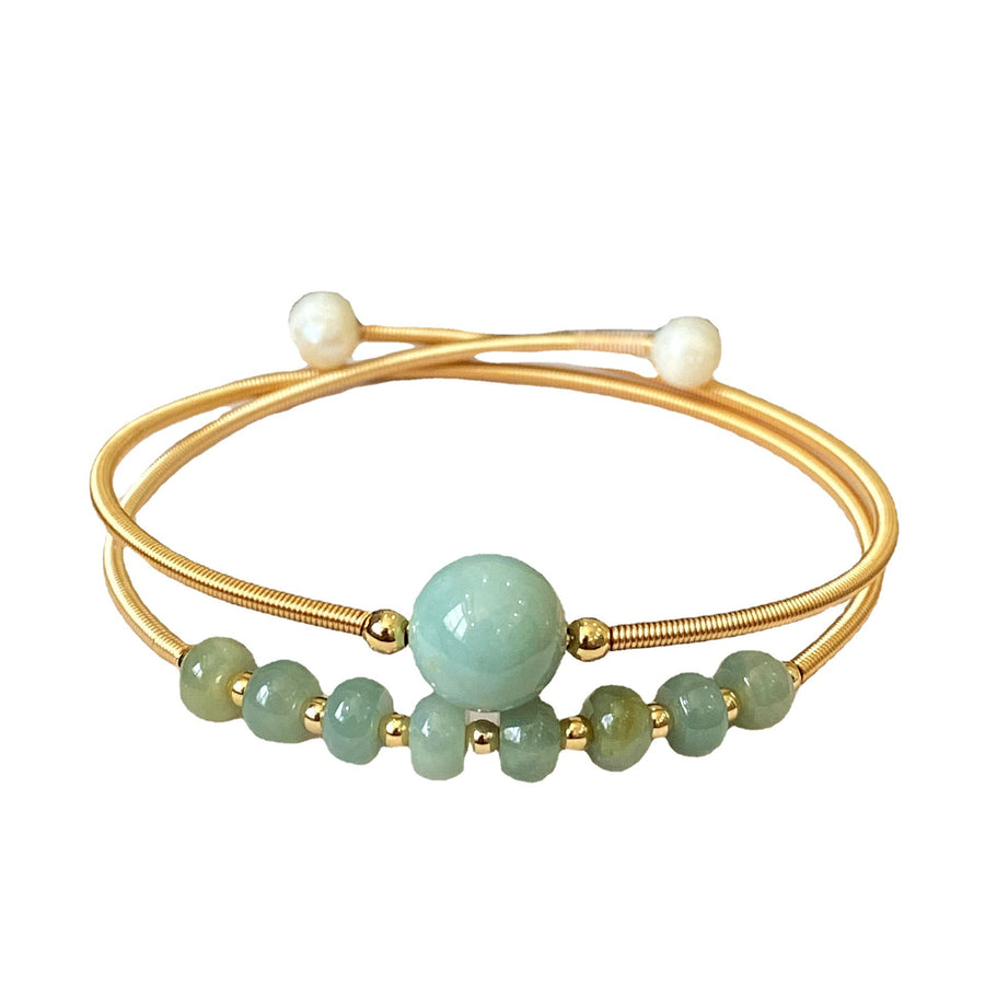 Gold-tone wire cuff bracelet with green jade center bead and white pearls