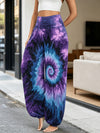 Model wearing purple tie-dye spiral pattern wide leg harem pants