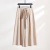 Gray wide leg cotton linen pants with a drawstring waist hanging on a hanger