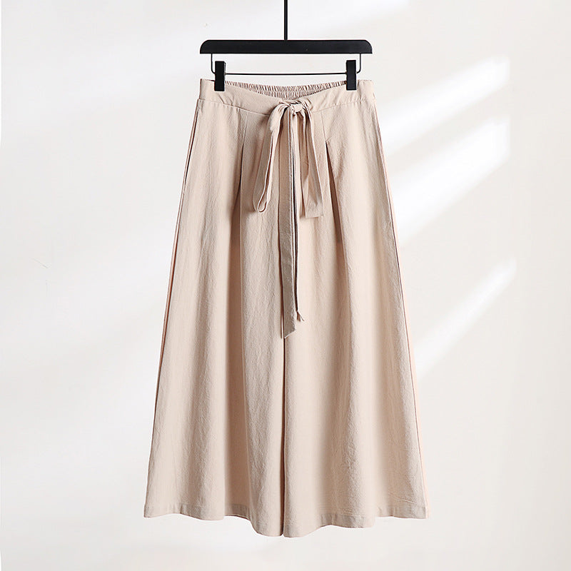 Gray wide leg cotton linen pants with a drawstring waist hanging on a hanger