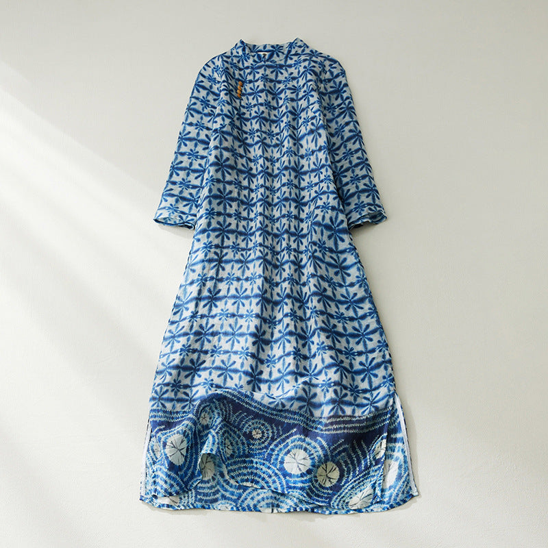 Flat lay of a blue and white floral print cotton linen midi dress with a stand collar