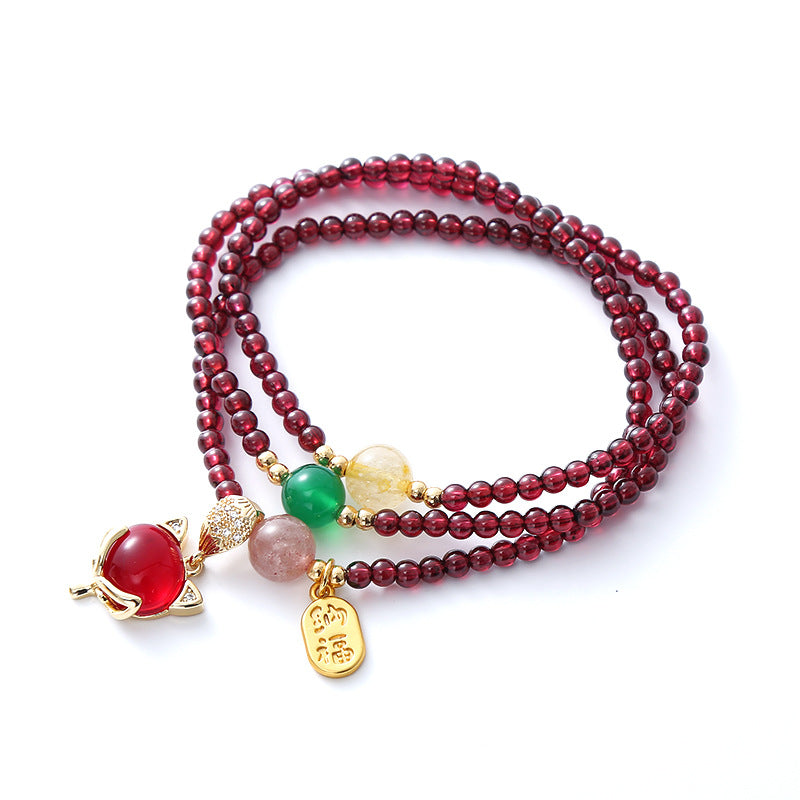 Triple wrap natural garnet bracelet with gold-tone fox charm and green bead accent