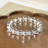 Close up of a clear crystal bead bracelet on a wooden tray