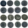 A collection of round dark metal stickers with various carved symbols including an owl, tree, and smiley face.