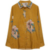 Woman wearing a yellow cotton linen shirt with large floral prints