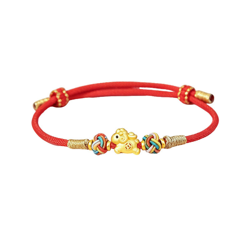 Close up of a red braided bracelet with a silver goat charm and beads