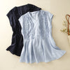 Two sleeveless V-neck tops with vertical ruffles laid flat, one light blue and one navy blue.