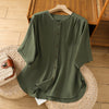 Green cotton linen half sleeve shirt with buttons on a wooden hanger