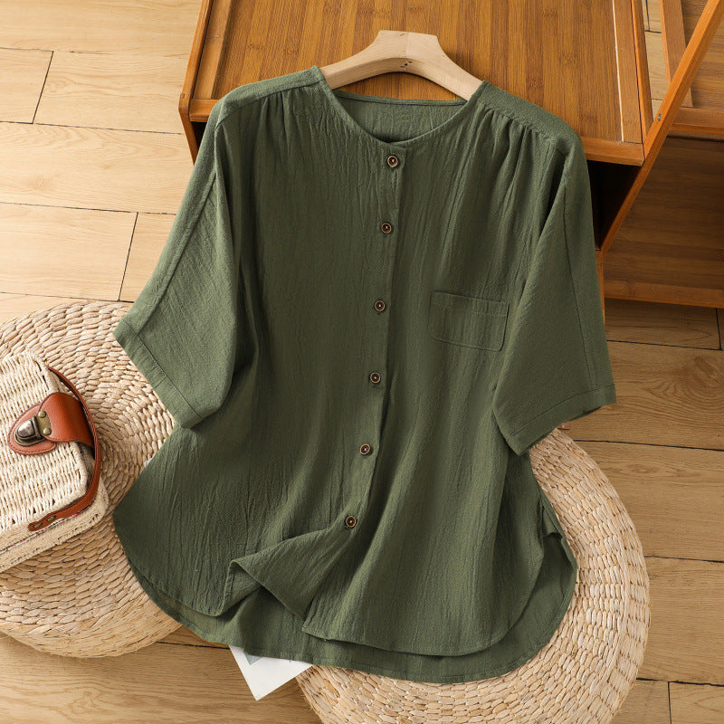 Green cotton linen half sleeve shirt with buttons on a wooden hanger