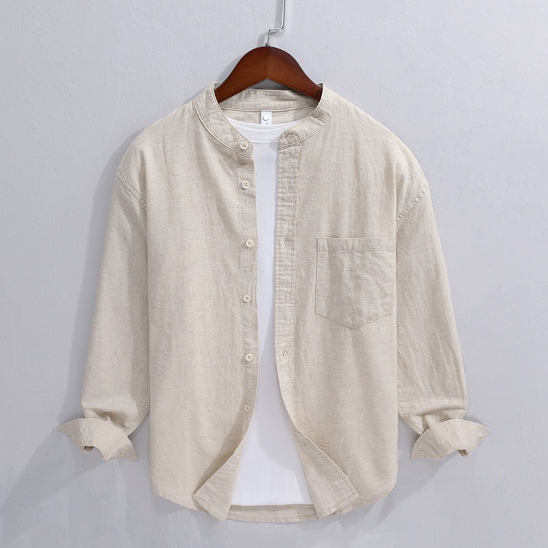 Beige linen cotton men's shirt with stand collar and chest pocket on a hanger