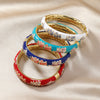 Four cloisonné enamel bangles with floral designs in different colors