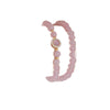 Close up of a wrist wearing a pink beaded bracelet with a gold charm